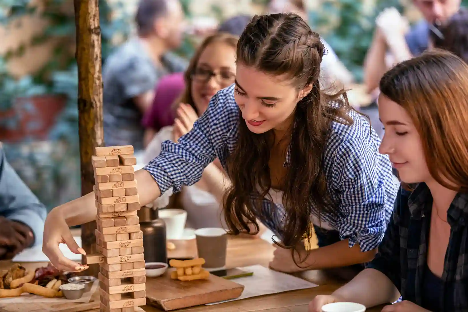playing-jenga-game-restaurant-with-best-friends-eating-tasty-snacks_11zon_11zon